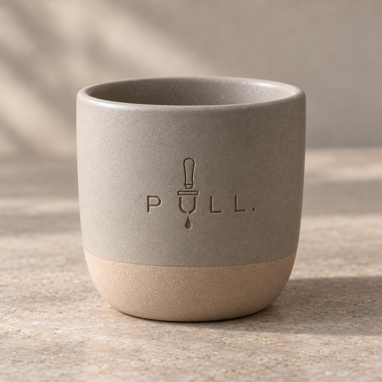 Matte grey ceramic mug with natural clay base and engraved Pull logo